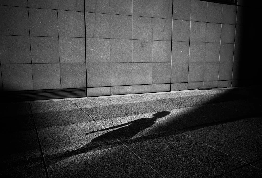 free-photo-of-shadow-of-walking-person-on-pavement.webp